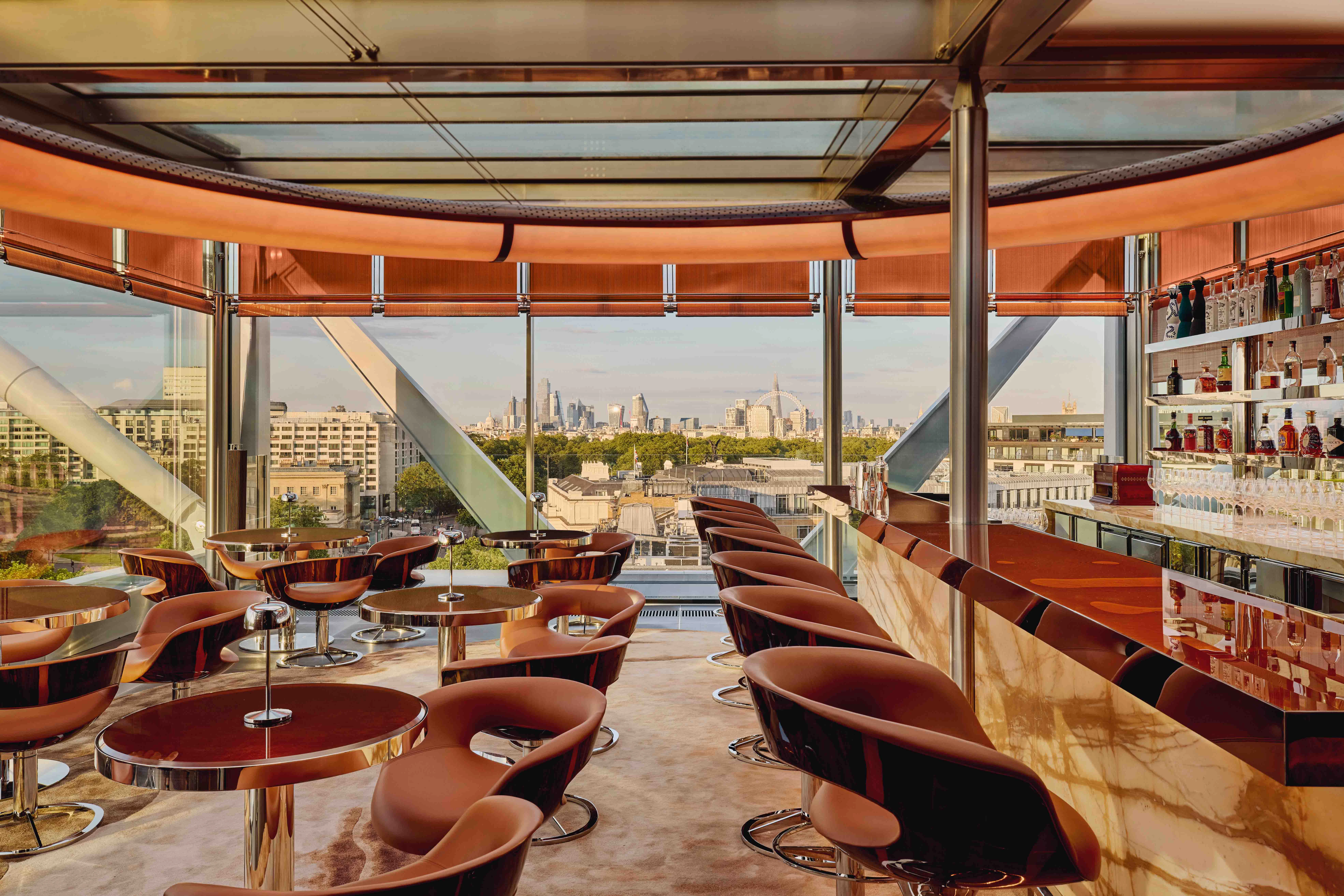 The City of London and London Eye from The Emory's Rooftop Bar at twilight.
