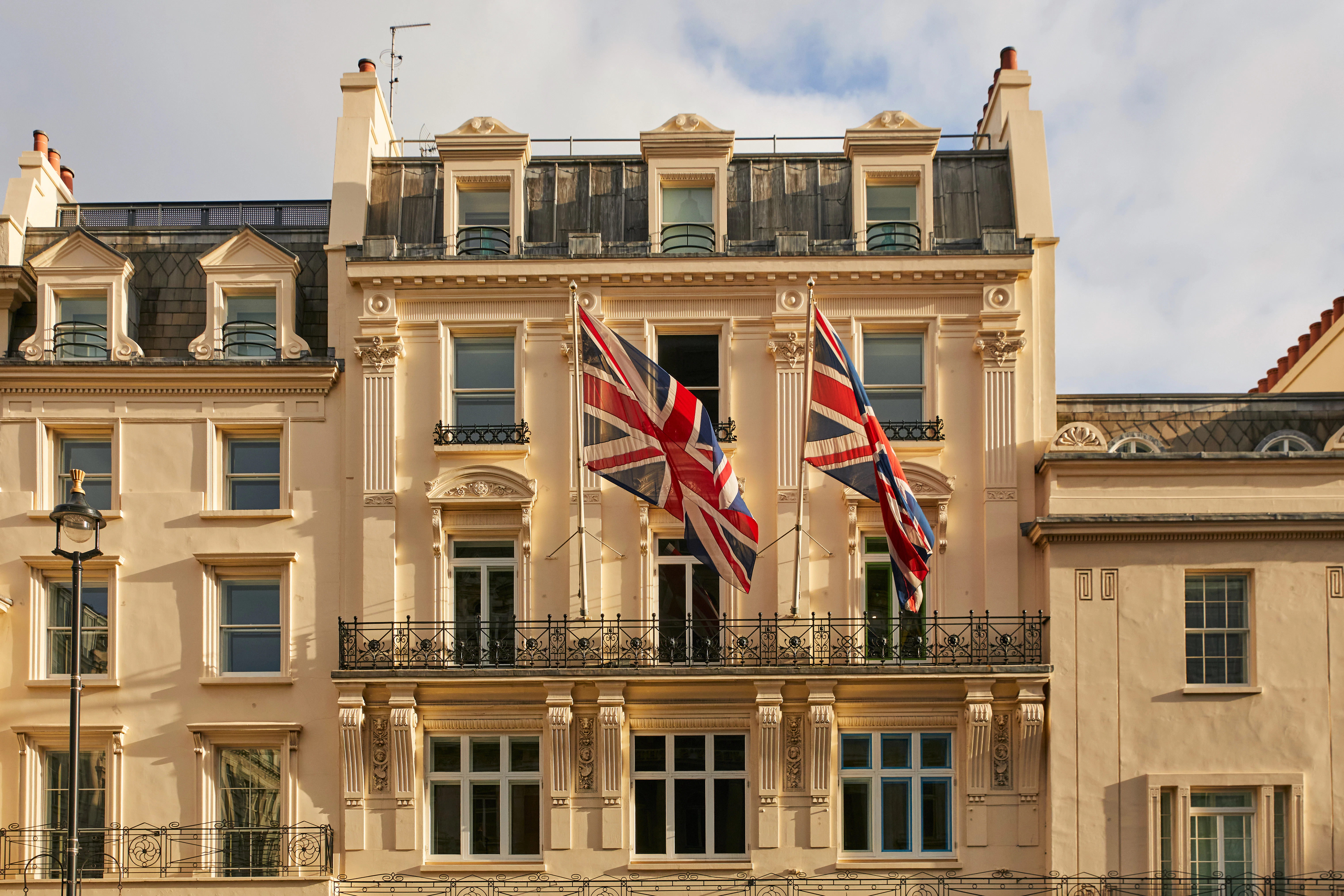 Haymarket Hotel's upper facade, with Union Flags flying in the breeze.