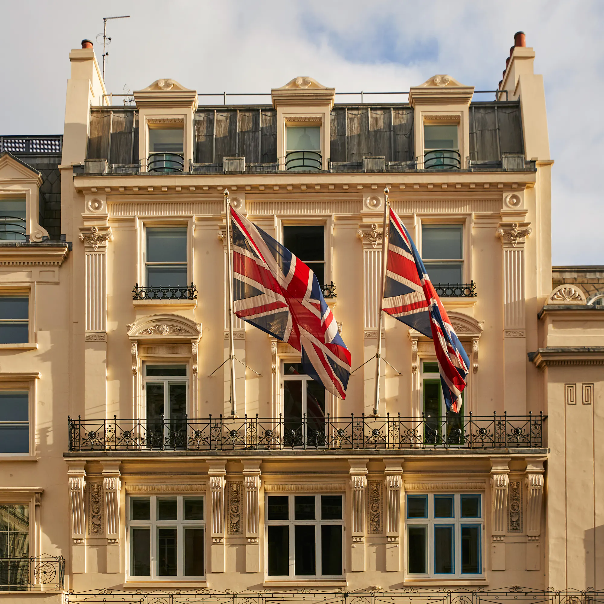 Haymarket Hotel's upper facade, with Union Flags flying in the breeze.