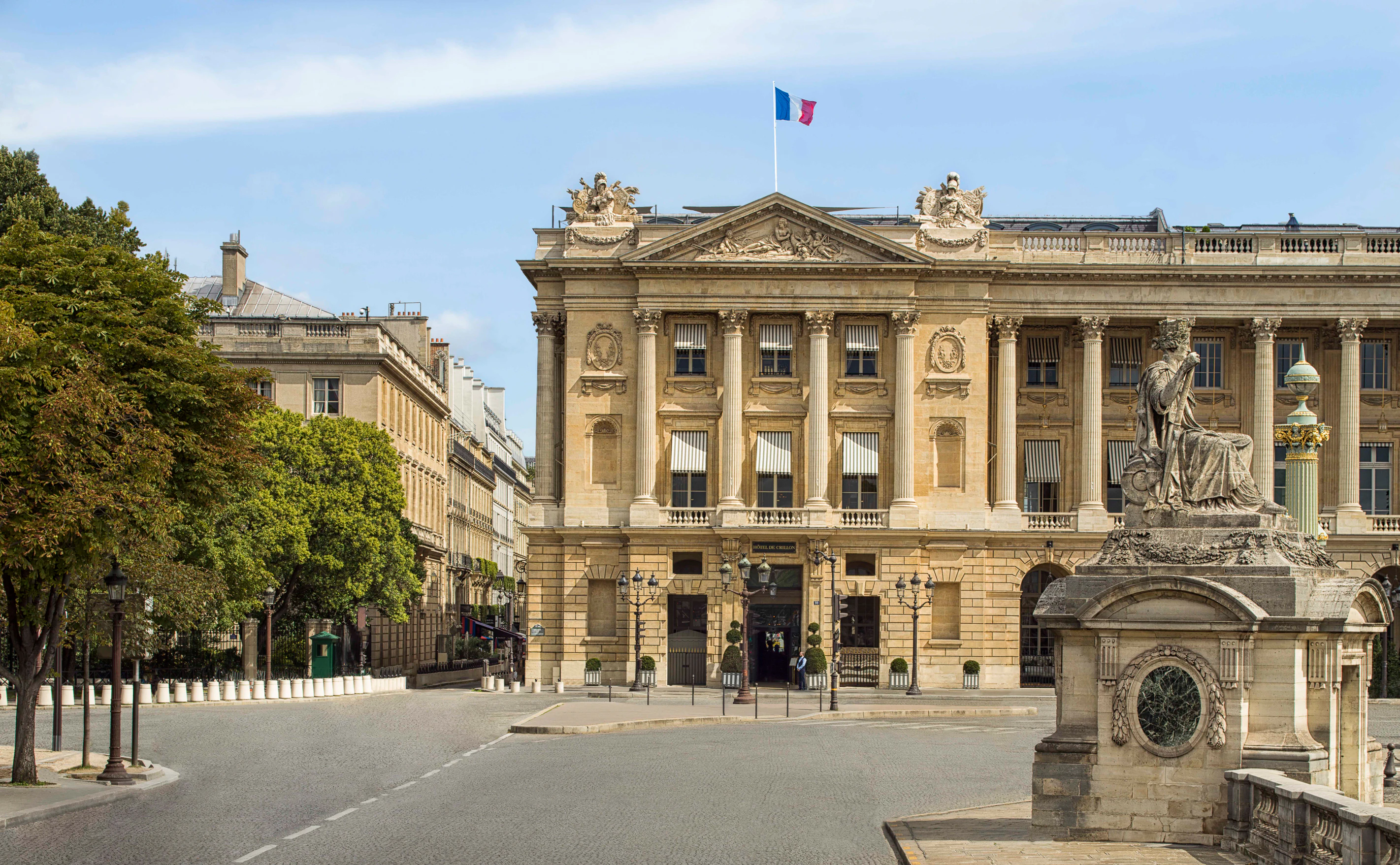 Hôtel de Crillon, A Rosewood Hotel, seen behind the Statue de Rouen on Place de la Concorde.