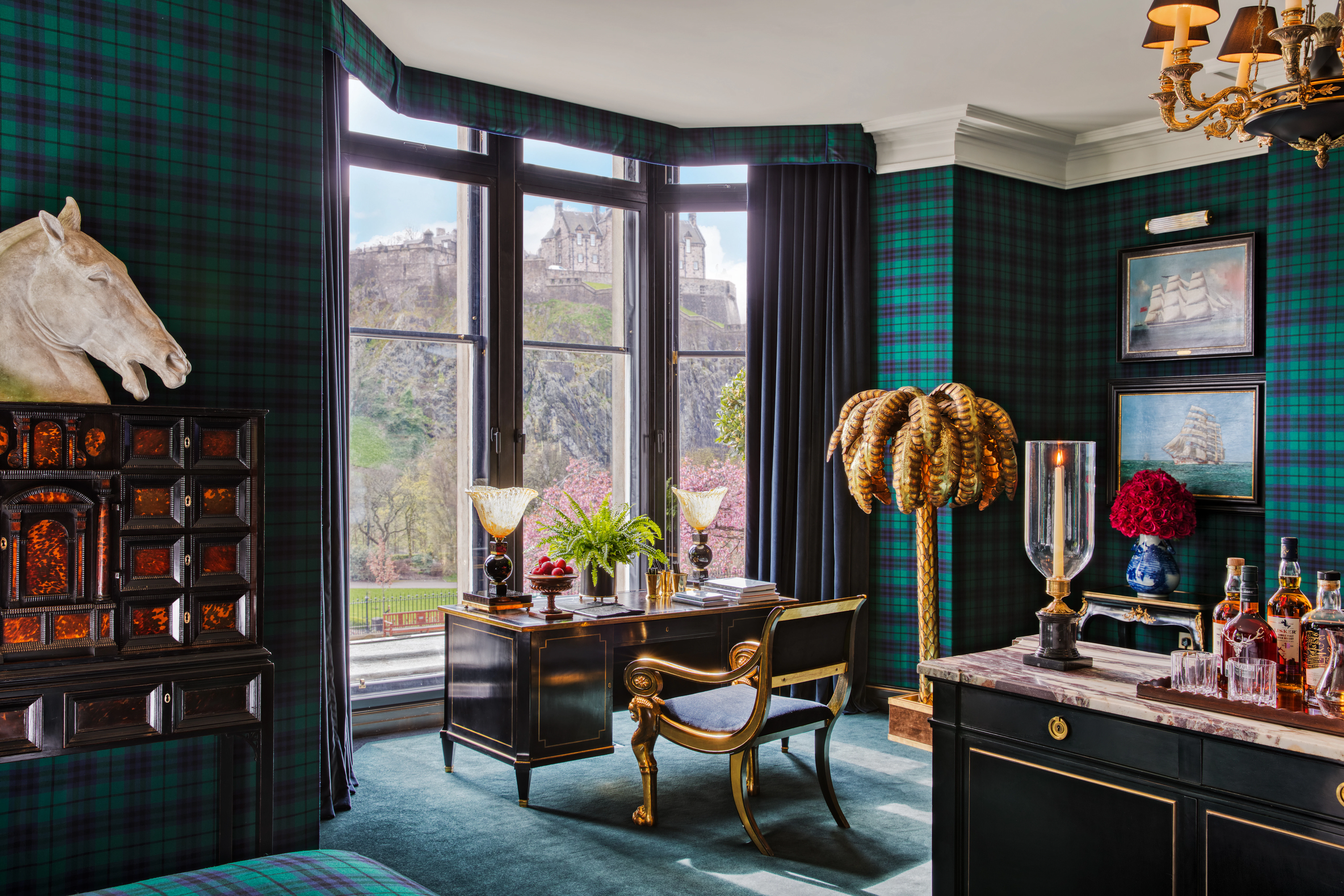 Edinburgh Castle framed in the bay window of a tartan suite at 100 Princes Street hotel.