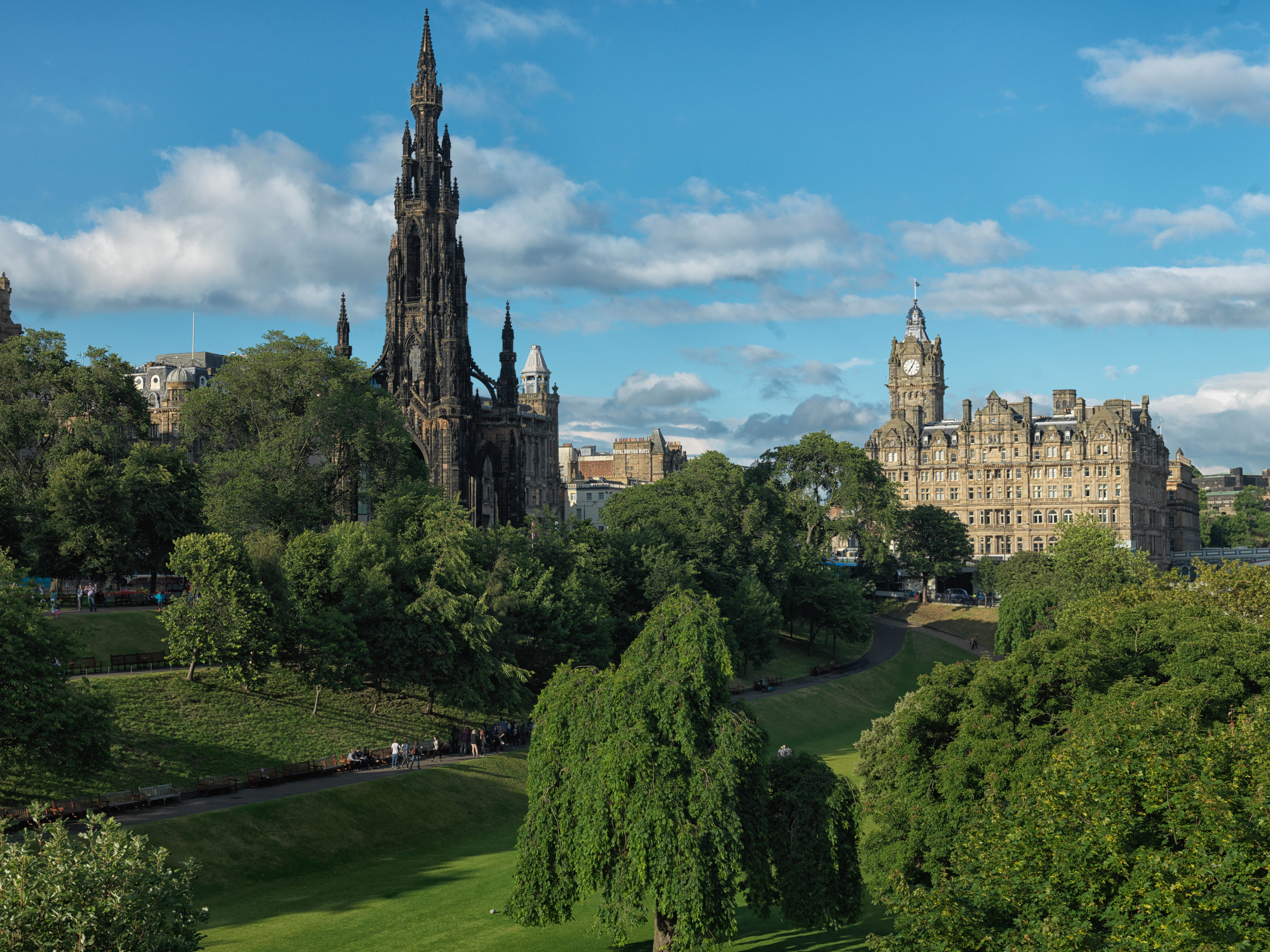 The Balmoral hotel's clock tower seen past the Scott Monument and Princes Street Gardens.